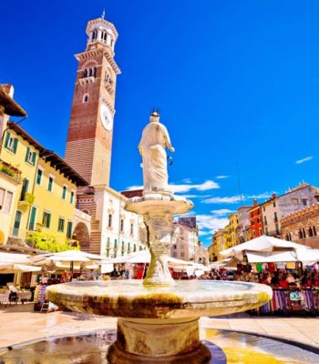 Piazza-delle-erbe-in-Verona-street-and-market-view-with-Lamberti-tower-tourist-destination-in-Veneto-region-of-Italy-min